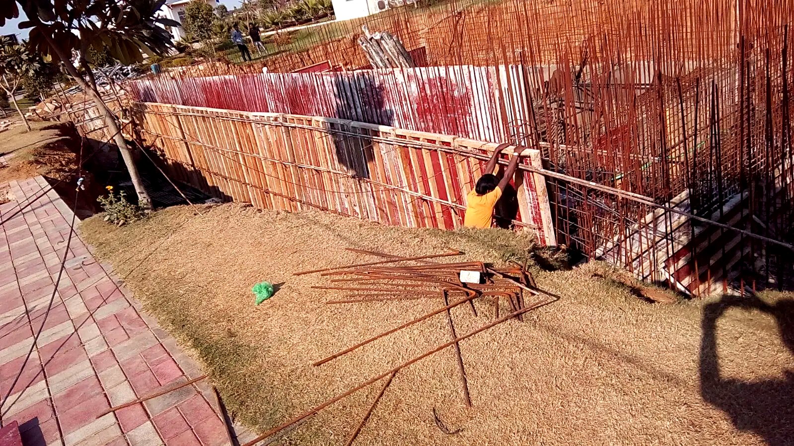 Site team erecting timber and steel shuttering panels along the sewage treatment tank wall line