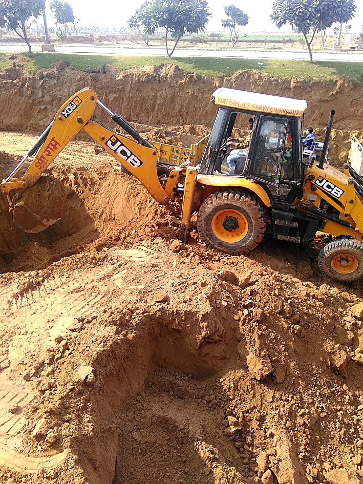 Excavator working in a deep excavation pit during sewage treatment plant civil construction at AMD Estates