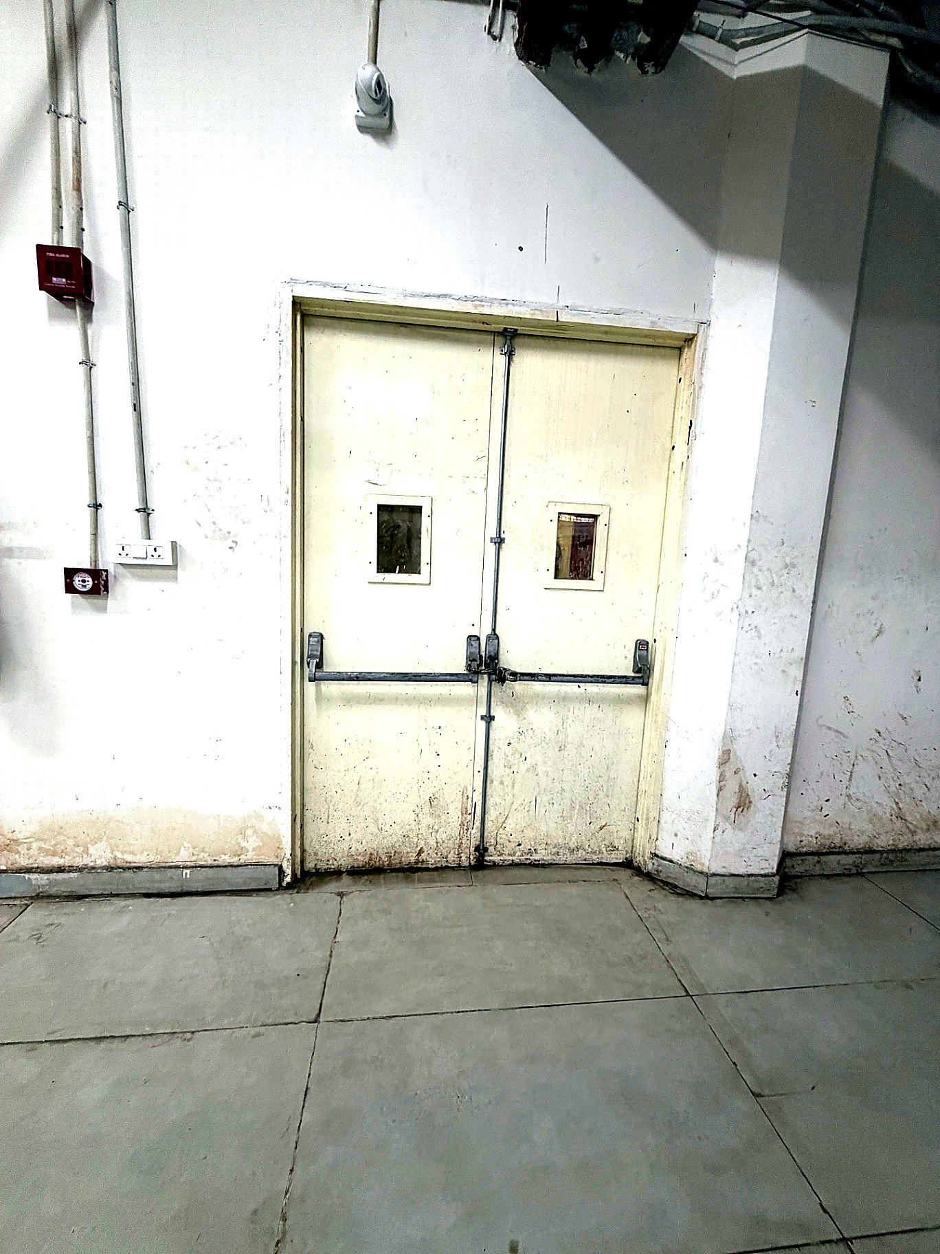 Fire-check door with panic-bar hardware installed at the Okhla Phase-1 commercial project by Decon Infratech